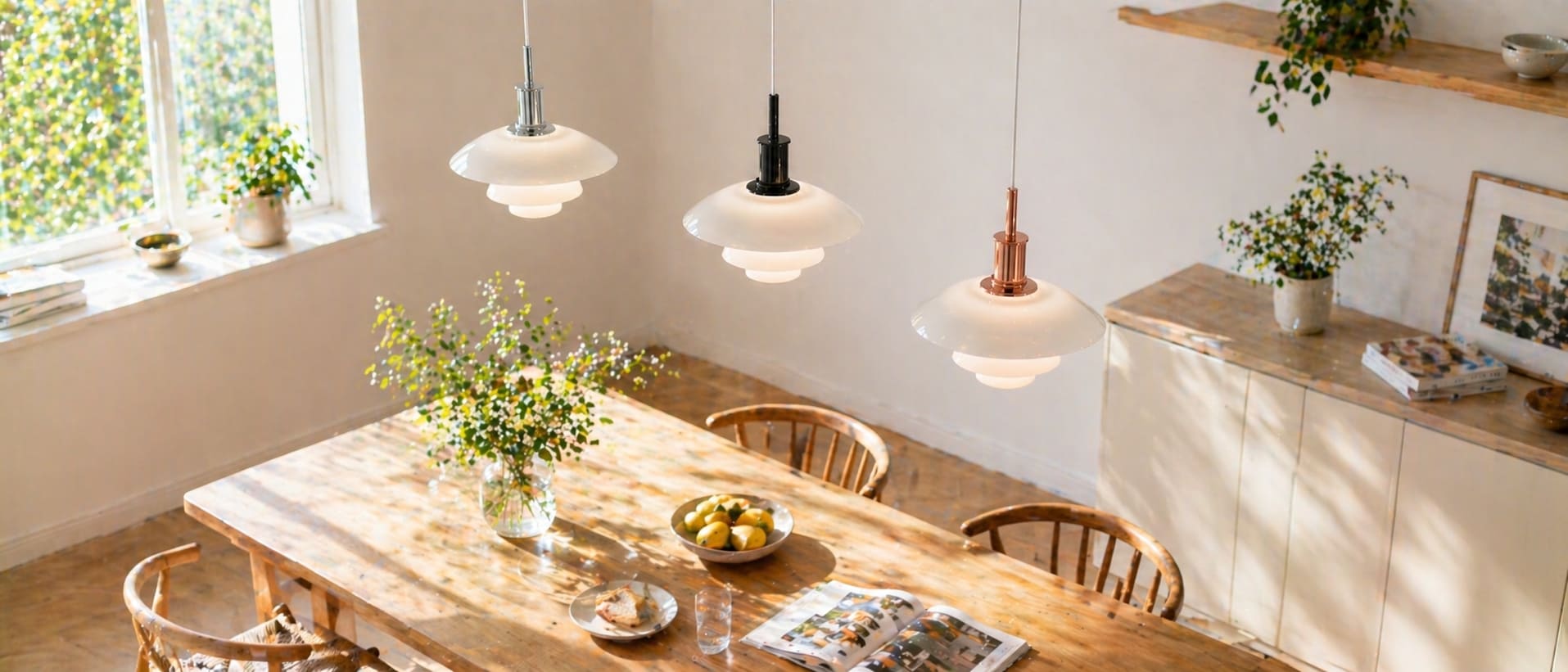 Three pendant lamp finishes styled above a sunlit dining table