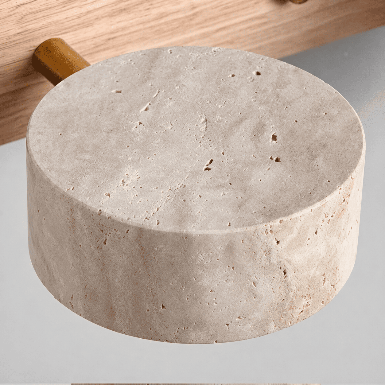 Close-up of travertine stone texture and wood base