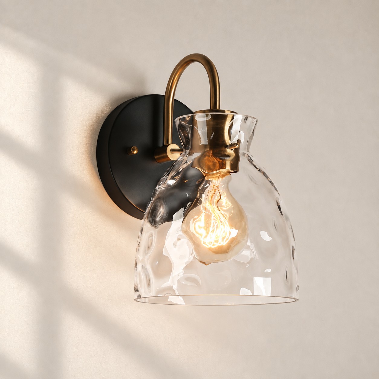 Textured Glass Wall Sconce with a clear shade and a visible bulb