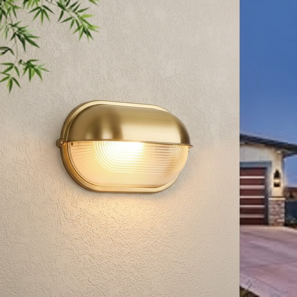 Docka gold wall lamp glowing on an outdoor wall