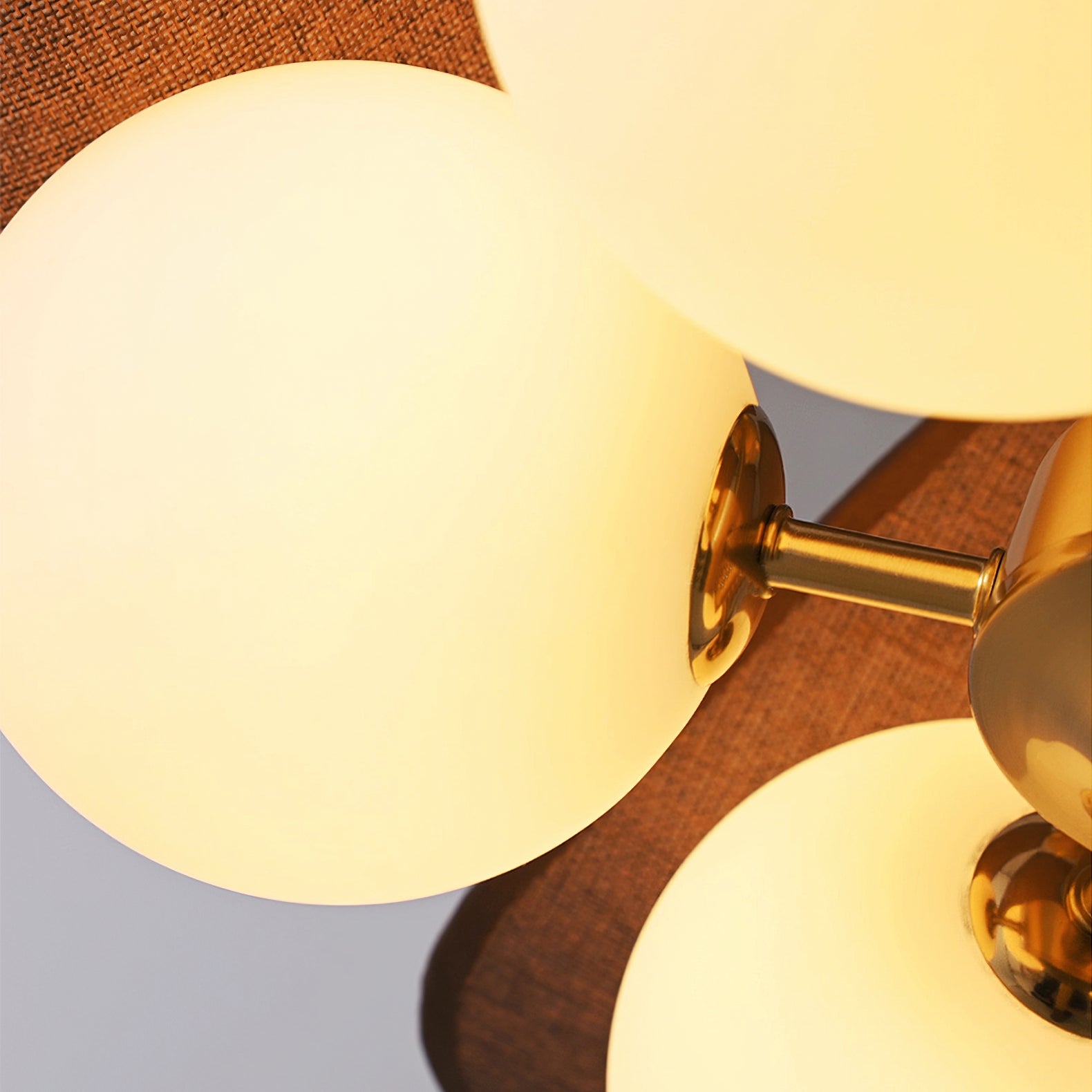 Close-up of Orrise glowing globe shade and metal arm