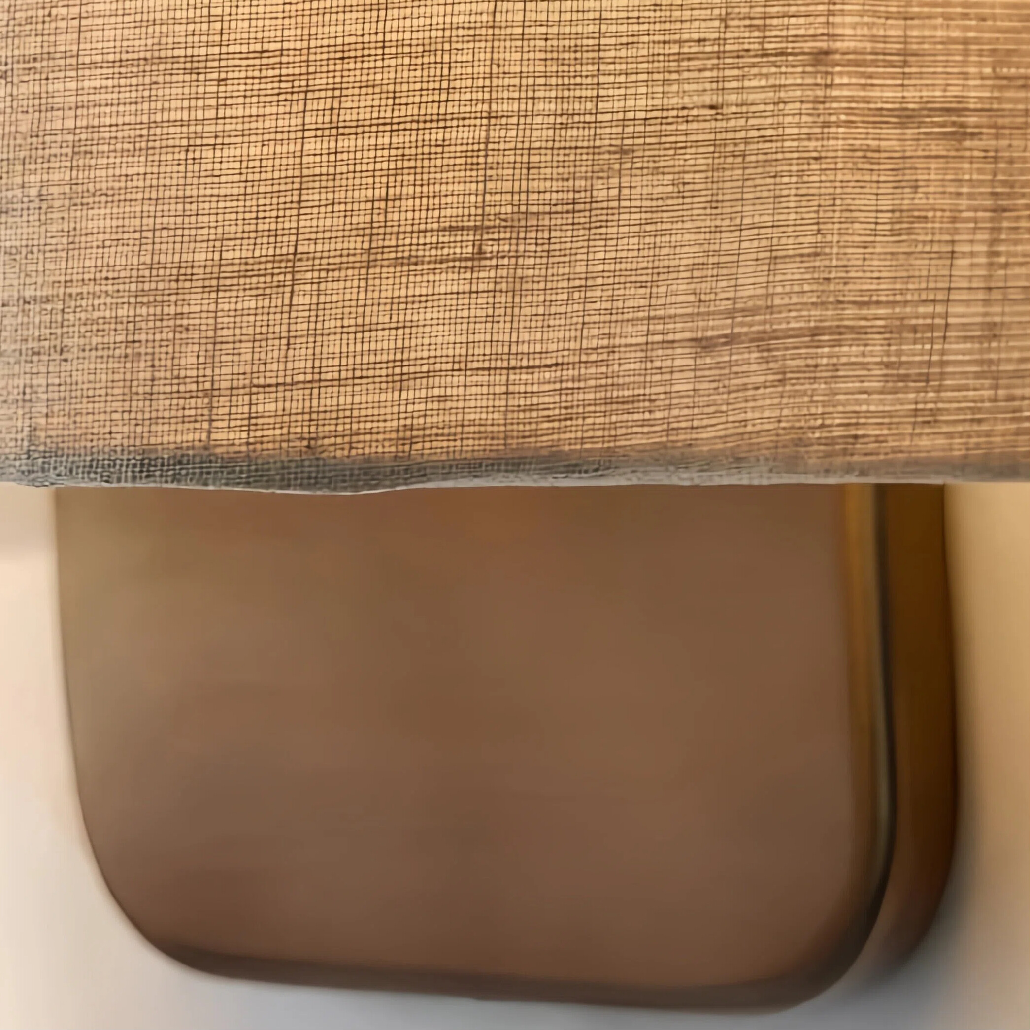Close-up of fabric shade and bronze metal base