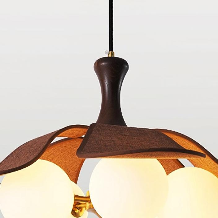 Close view of the Orrise pendant wood and globe shade detail