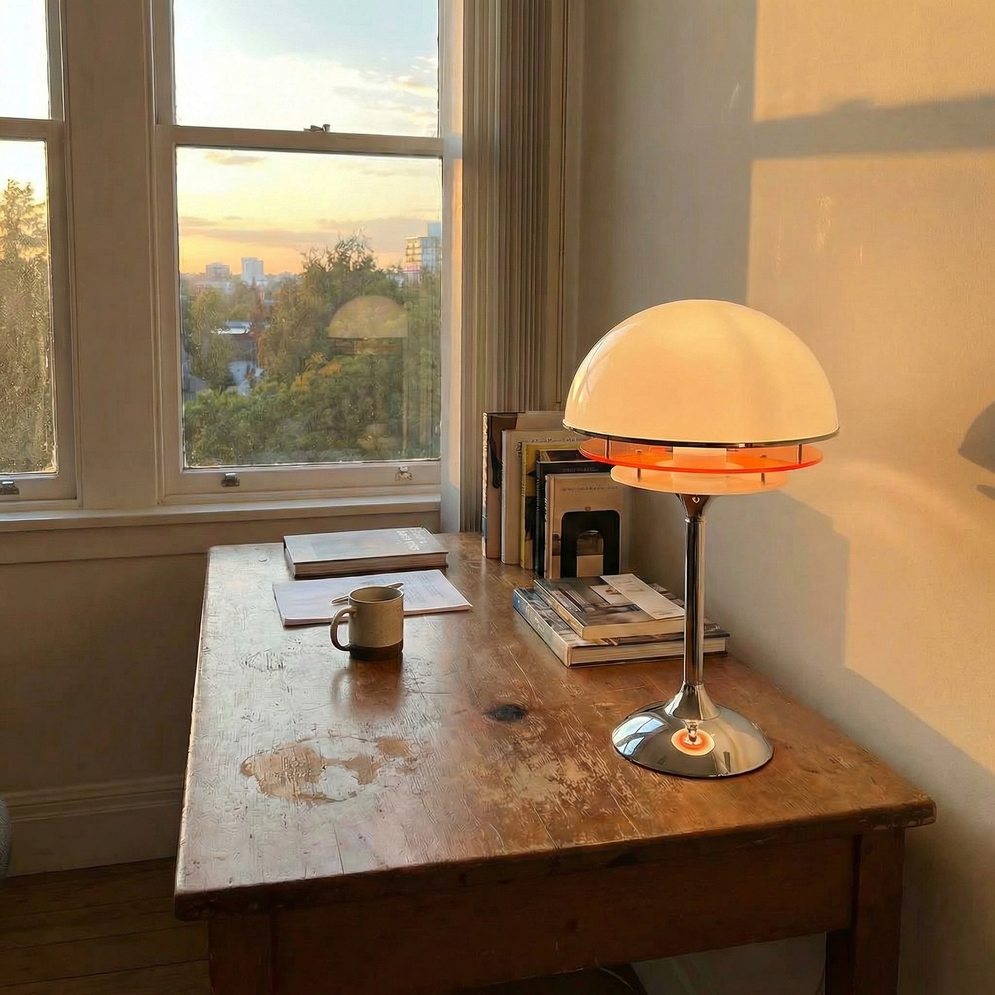 Afterglow Sunset Glow table lamp on a wooden desk