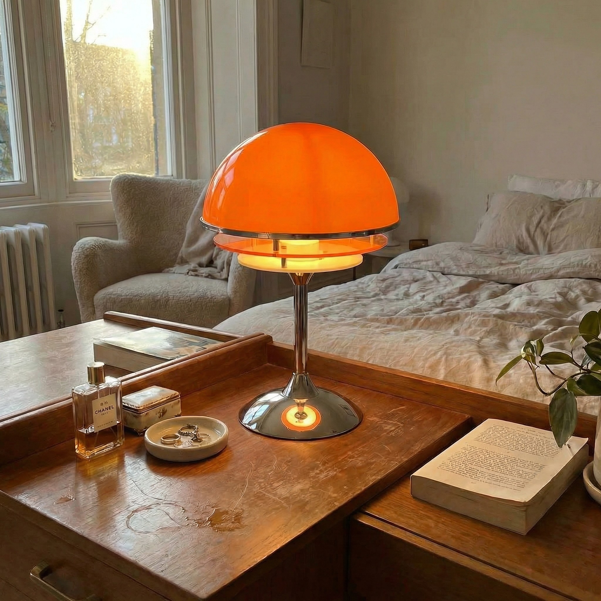 Orange Afterglow Sunset Glow table lamp on a bedside table