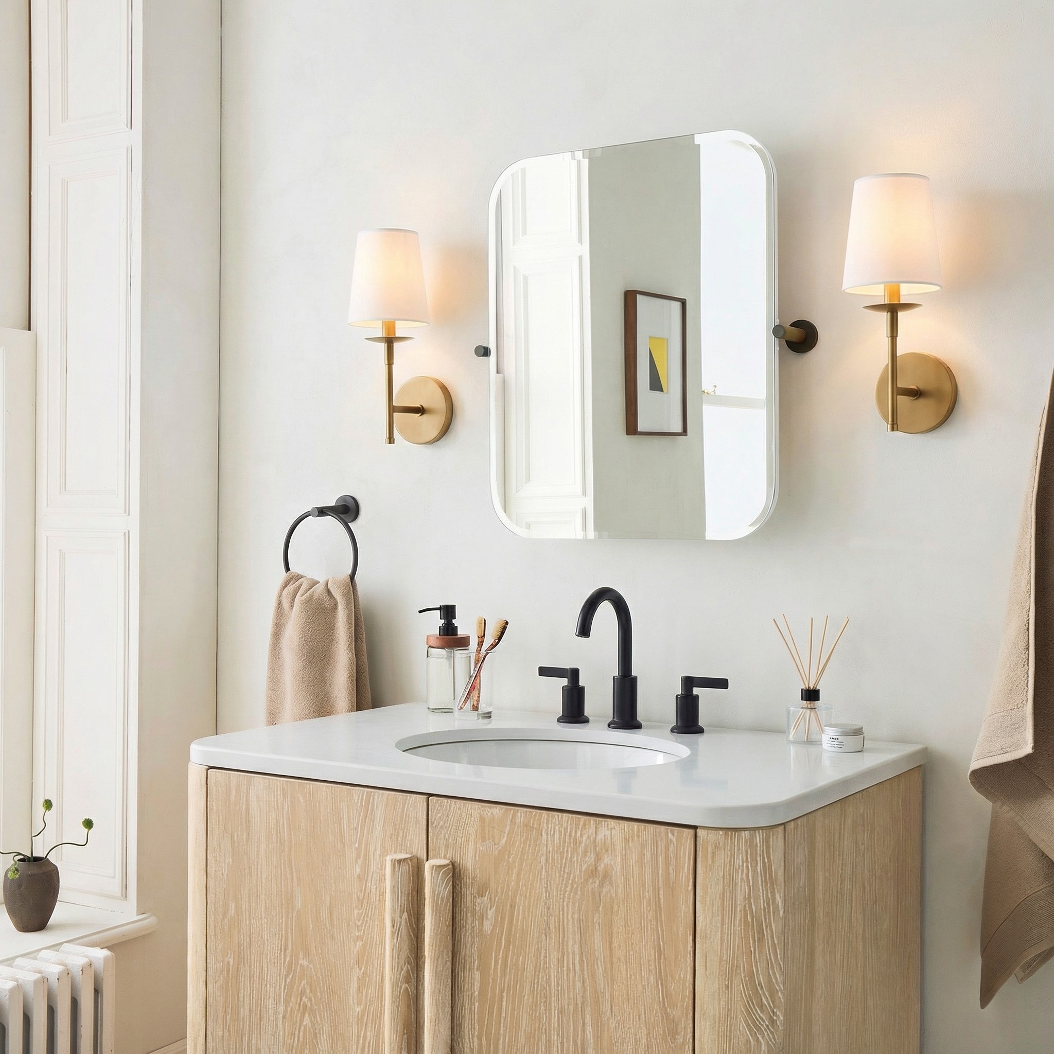 Rowan wall sconce beside a bathroom mirror