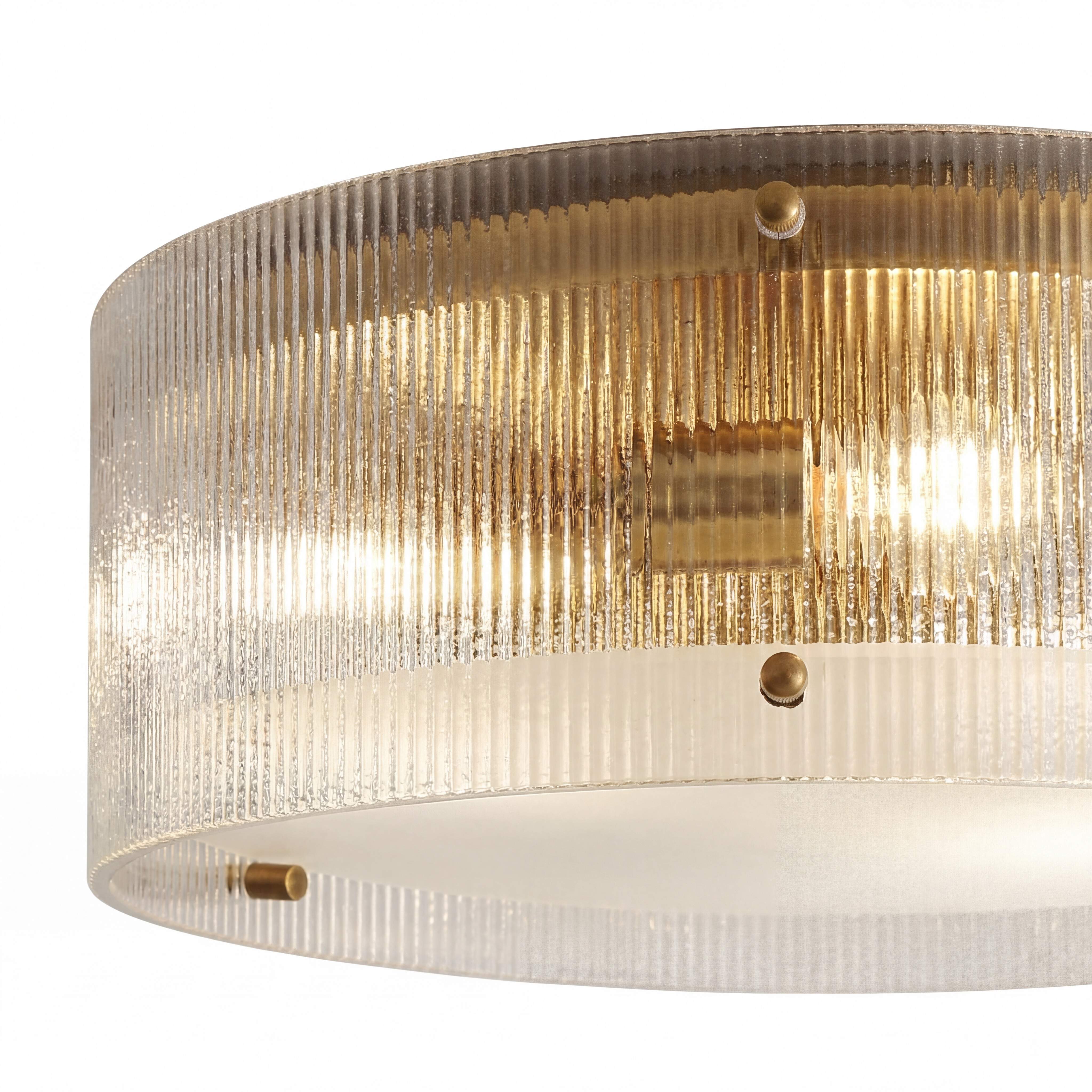 Close-up of Ribella fluted glass brass round ceiling light illuminated