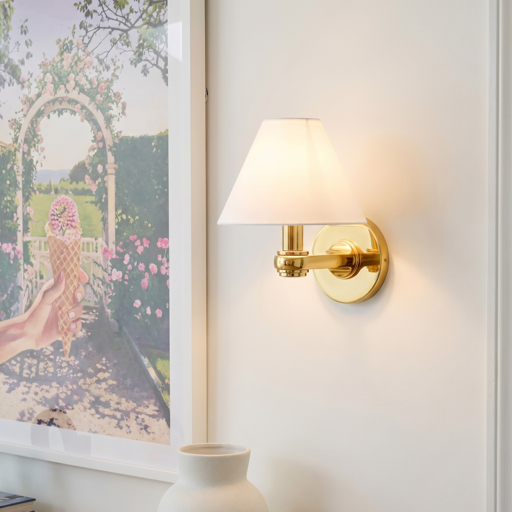 Roven single sconce glowing on a wall