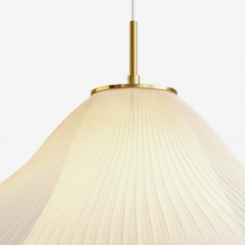 Gold pendant stem and glowing fabric shade detail