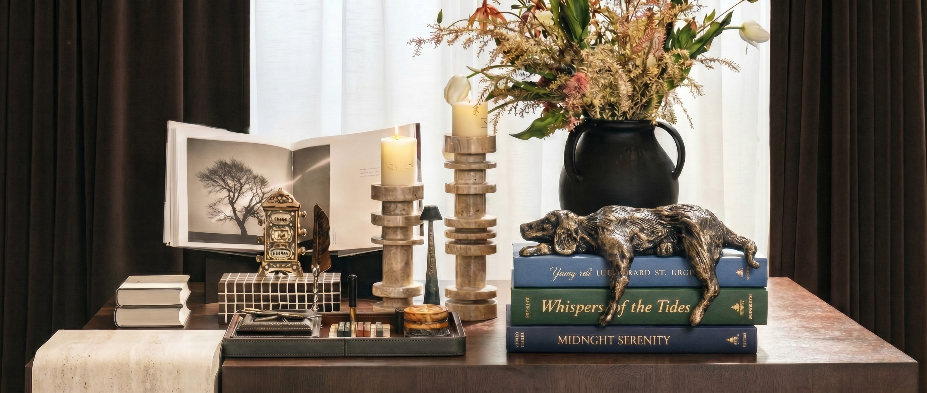 Floxo lazy dog sculpture styled on stacked books with candles, vase, and home decor