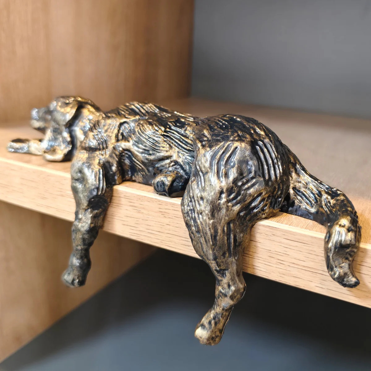 Geometric iron dog figurine showing sculpted bronze finish