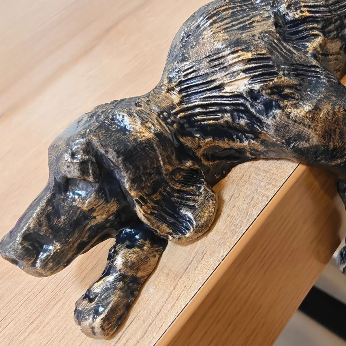 Close-up of the bronze textured iron lazy dog figurine