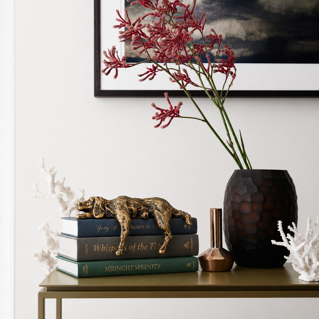 Geometric dog sculpture arranged with vase and framed wall art