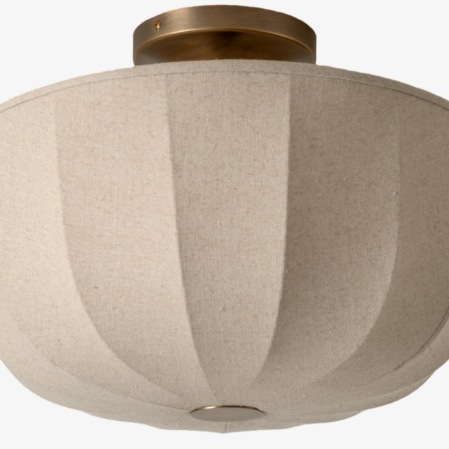Close view of the Loomis linen shade and aged brass detail