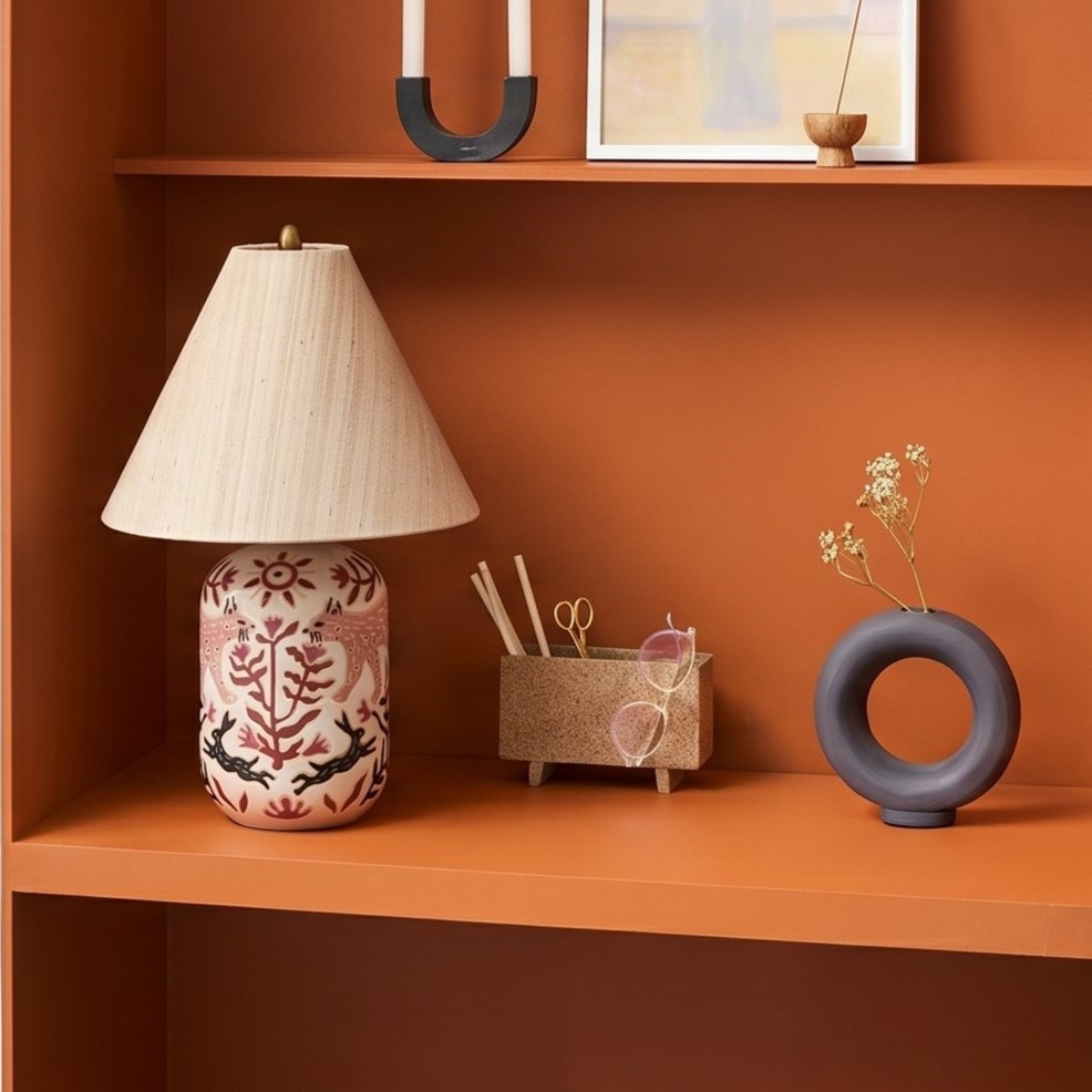 Ceruna ceramic table lamp on warm orange shelving