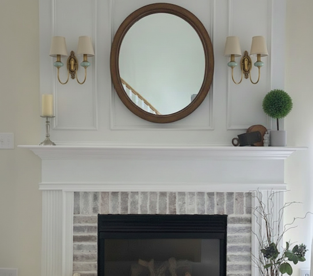 Rowanea wall sconces displayed above a mantel and round mirror
