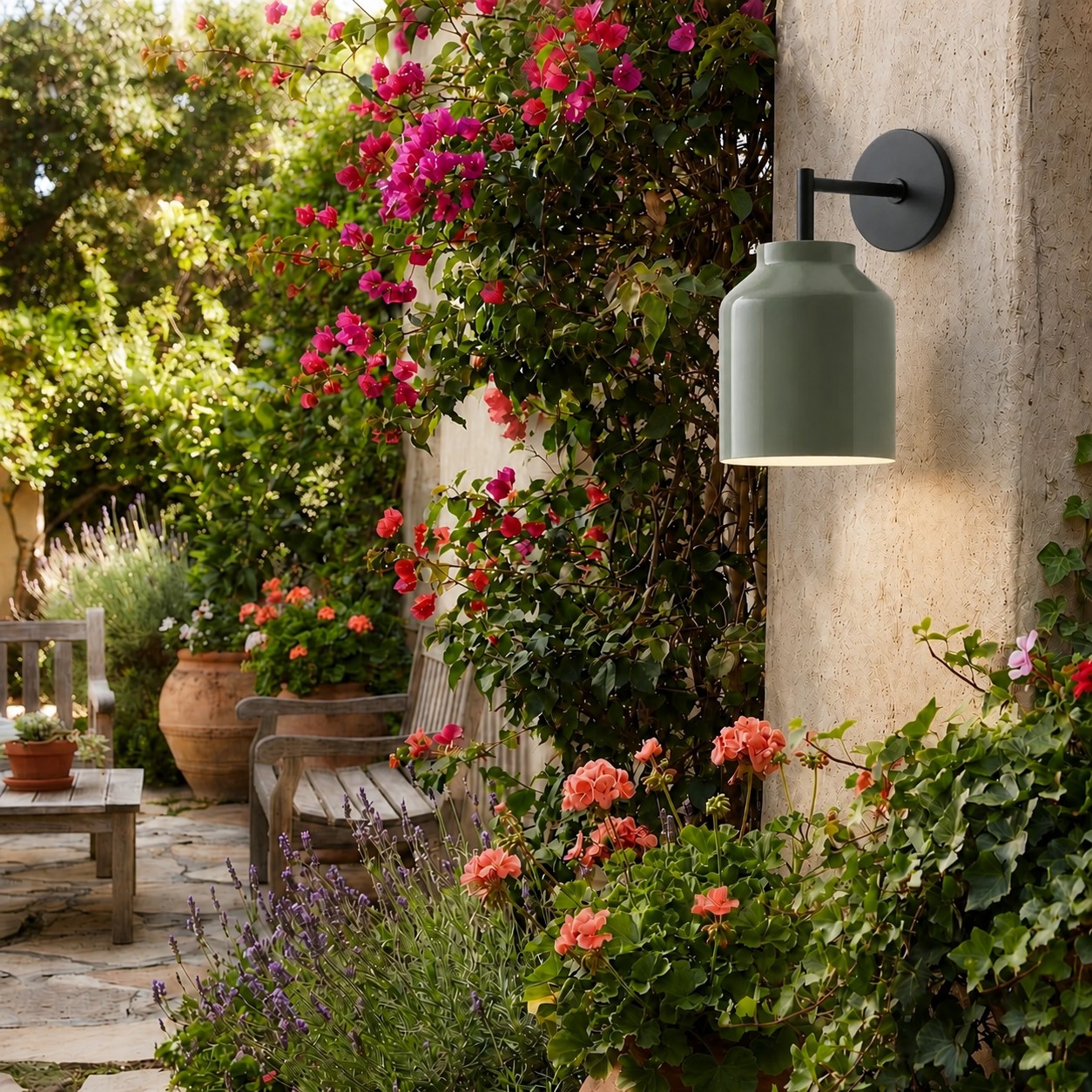 Dark olive Hanton wall sconce in a garden setting
