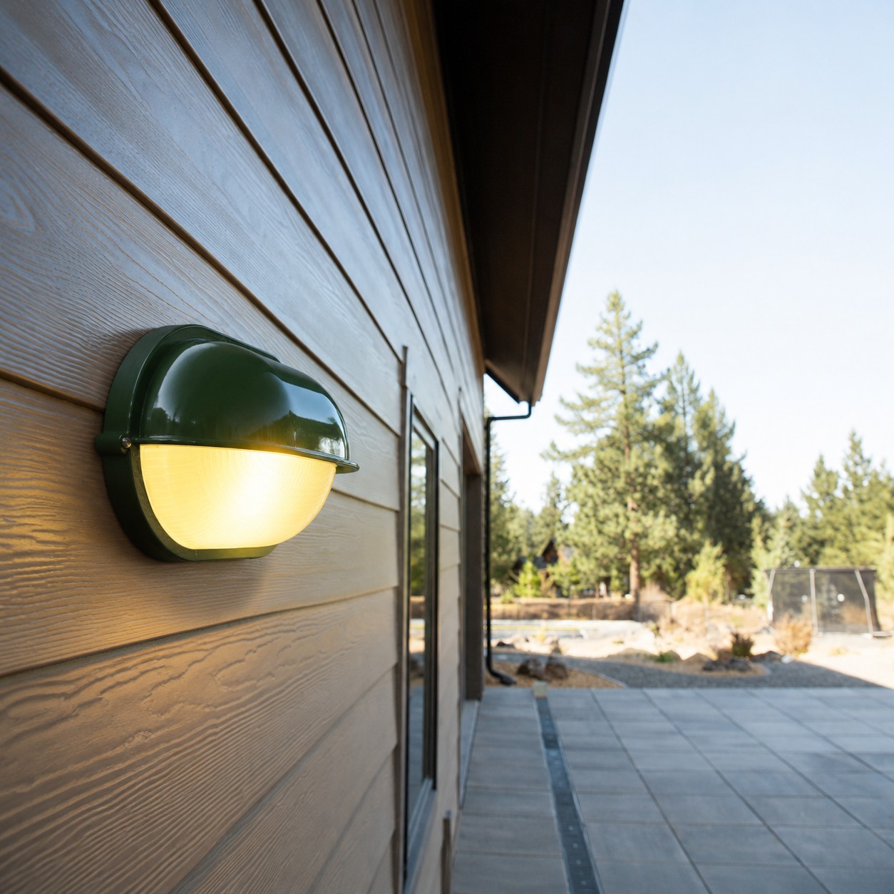 Docka outdoor wall lamp installed on a wood exterior wall