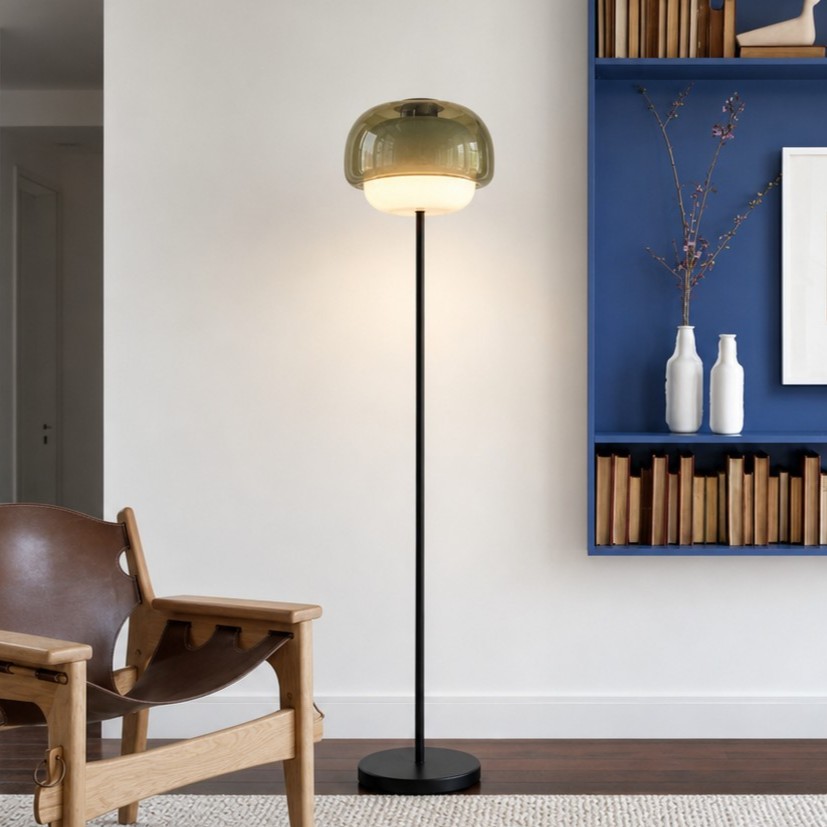 Clinco floor lamp glowing near a chair and blue shelving
