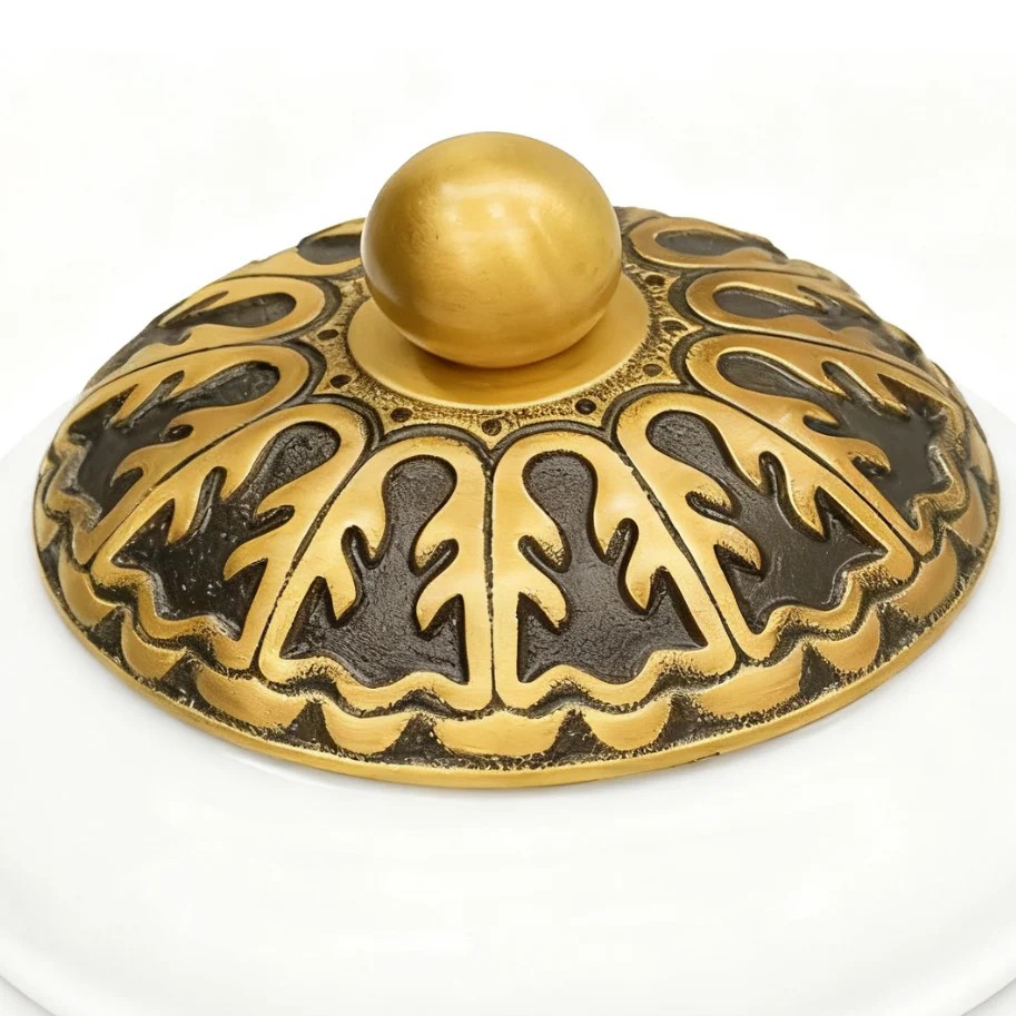 Detail view of Eloise brass finial and decorative metalwork