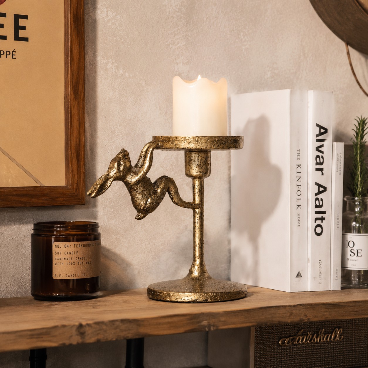 Tall Aura gold candlestick holder styled on a wooden tabletop