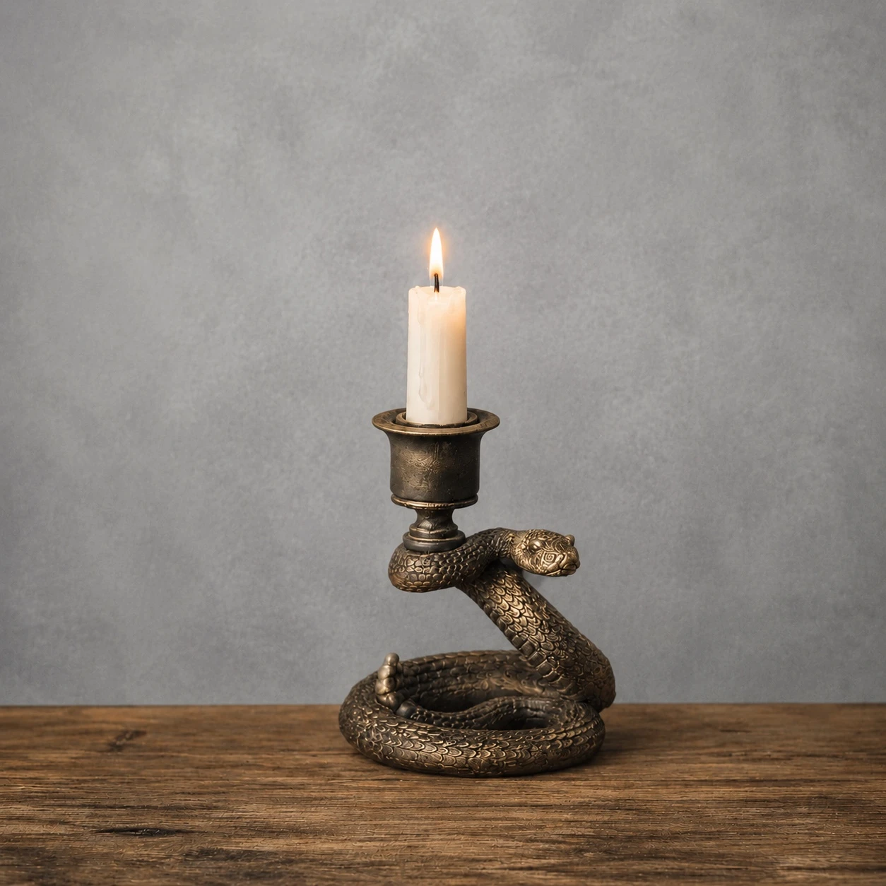 Aura Snake Candlestick in antique dark bronze finish with taper candle