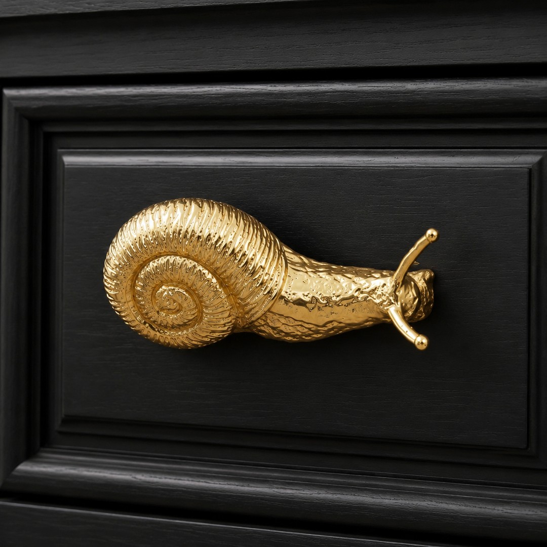 Installed close detail of the brass snail cabinet knob on a drawer front