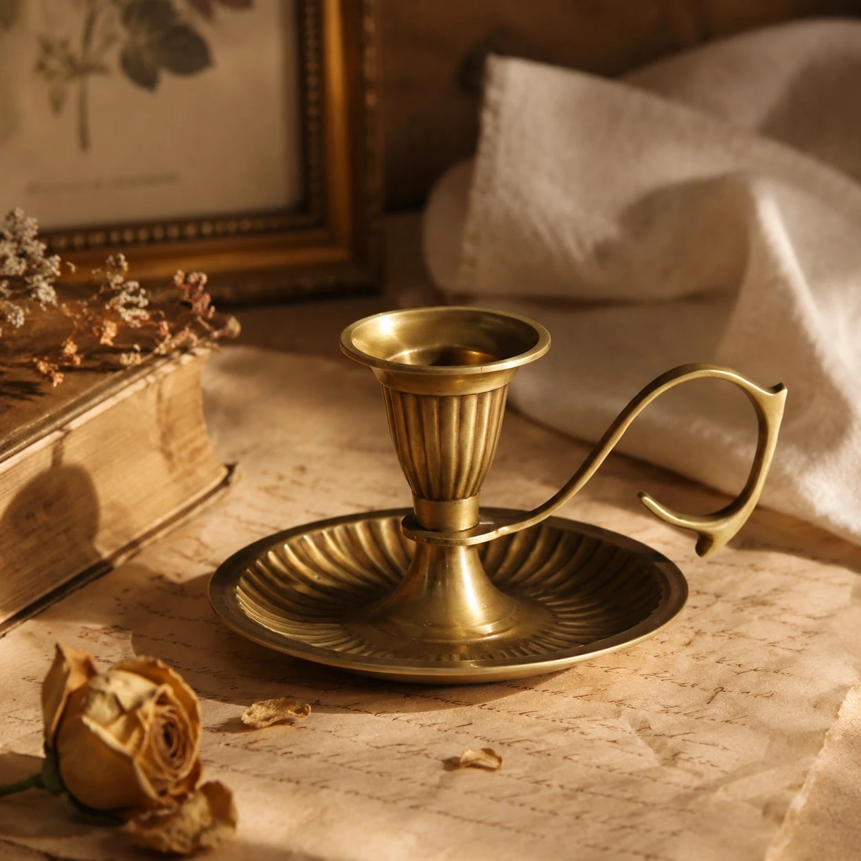 Aura brass candlestick in a warm vintage tabletop setting