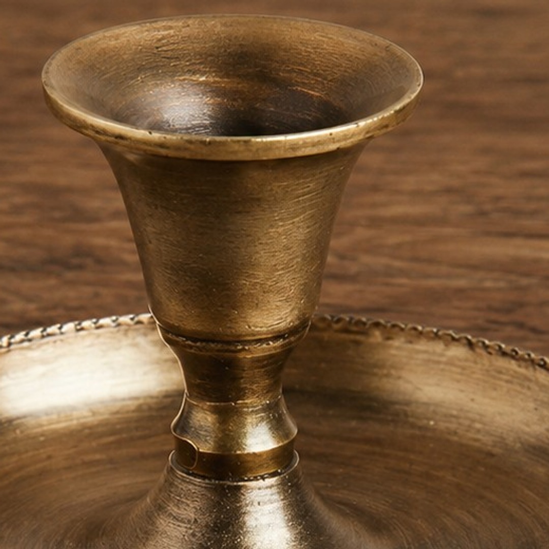 Close-up of brushed antique gold copper texture on Aura candlestick