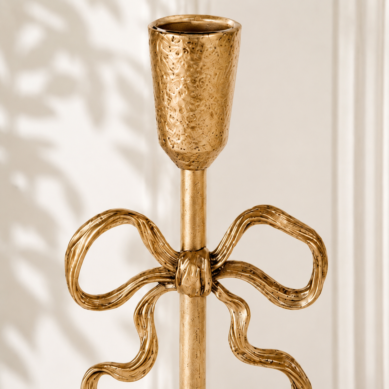 Close view of Aura candlestick cup and bow form