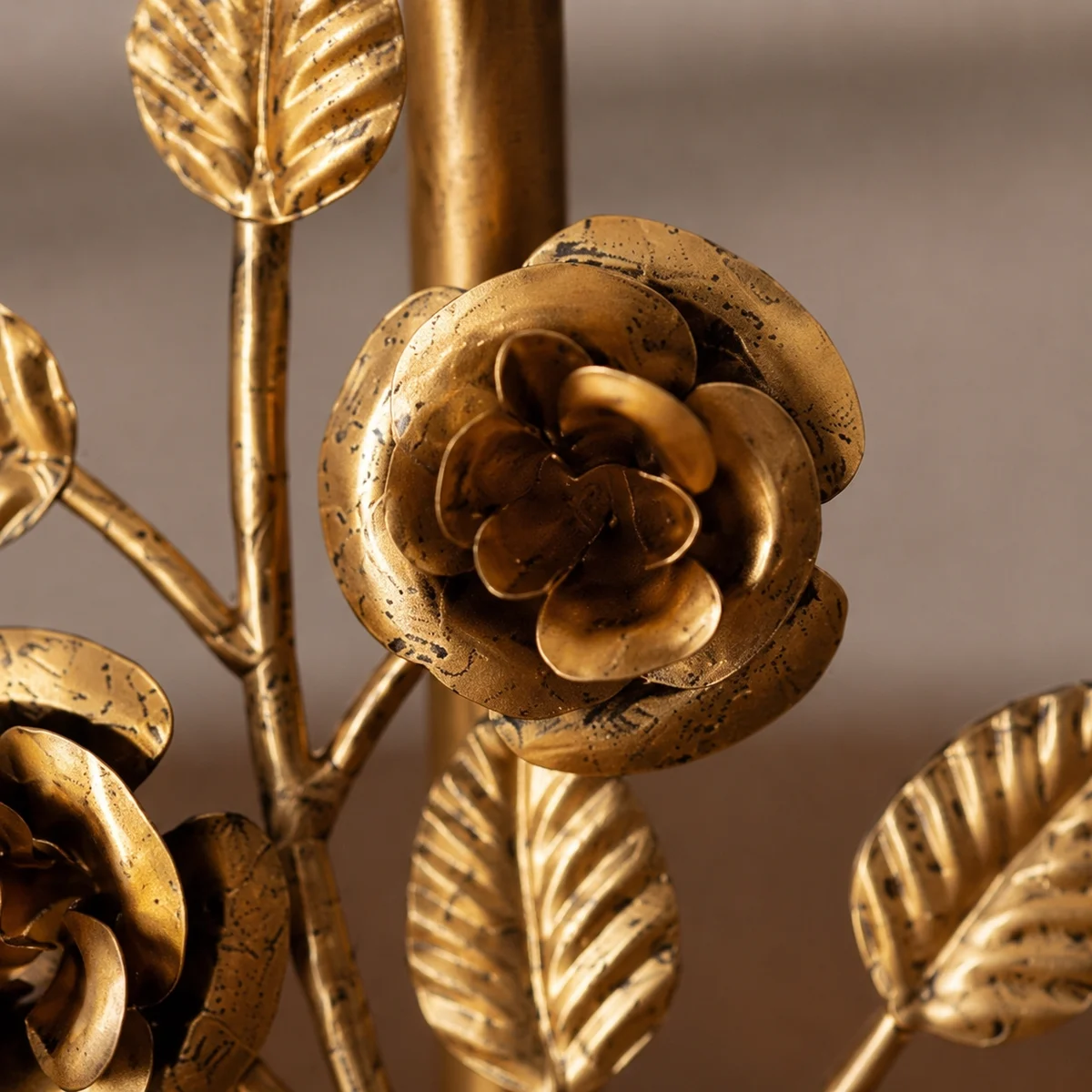 Macro detail of antique brass rose petals and leaf texture