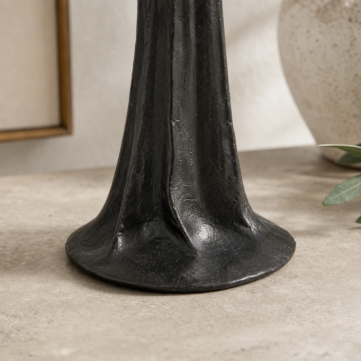 Close-up of the flared base and textured black resin lower robe