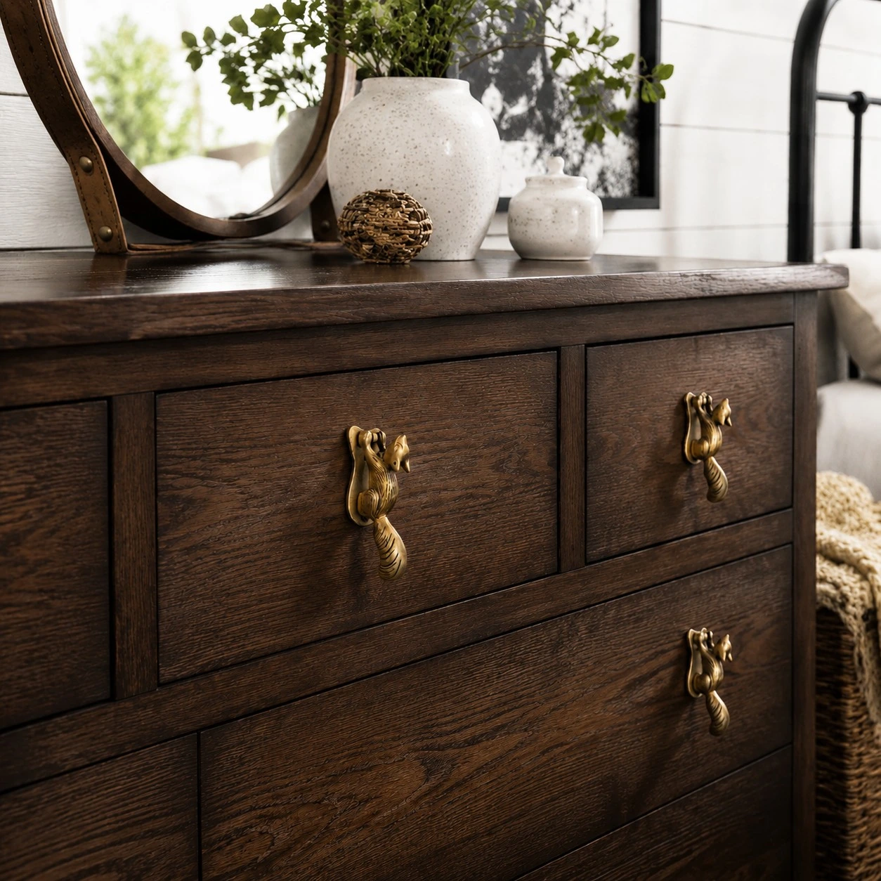 Totem squirrel brass handles on a dark wood dresser