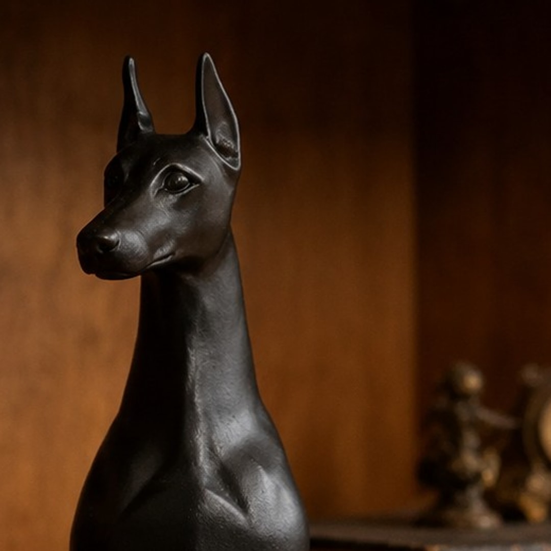 Close-up of the Doberman ornament styled on a bookshelf
