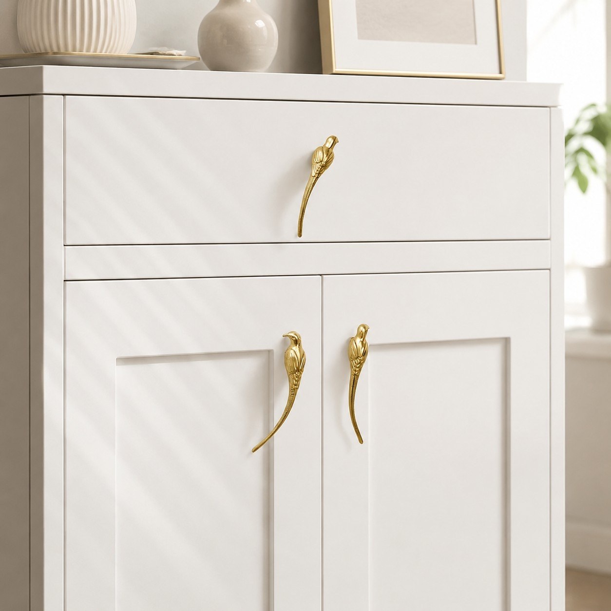 Totem brass handles installed on a white cabinet