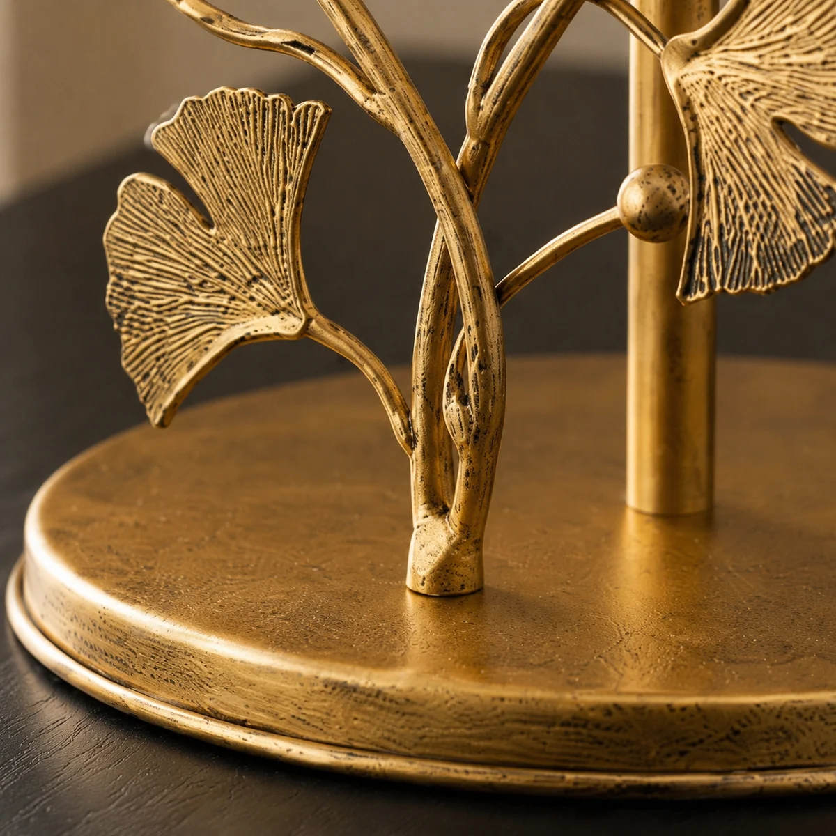 Close detail of ginkgo leaf stems and aged brass base rim