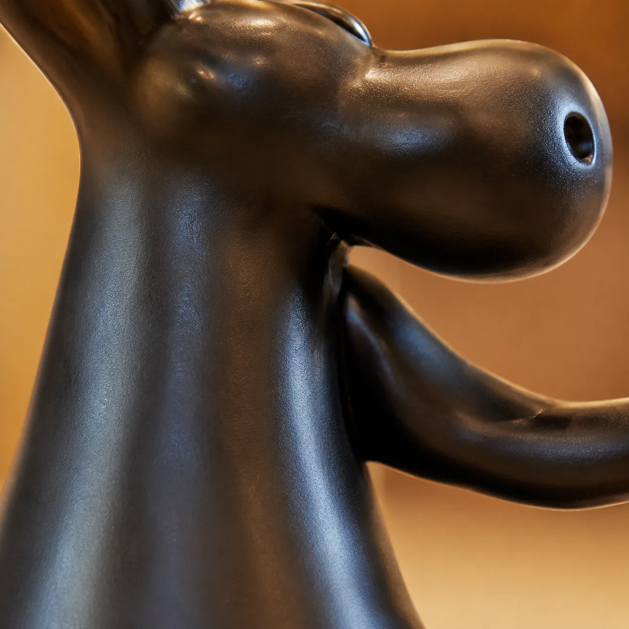 Close-up of the glossy black resin sculptural curve