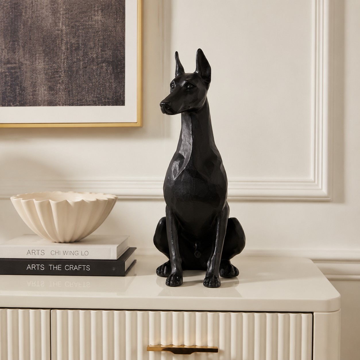 Black Doberman resin ornament styled on a cream cabinet