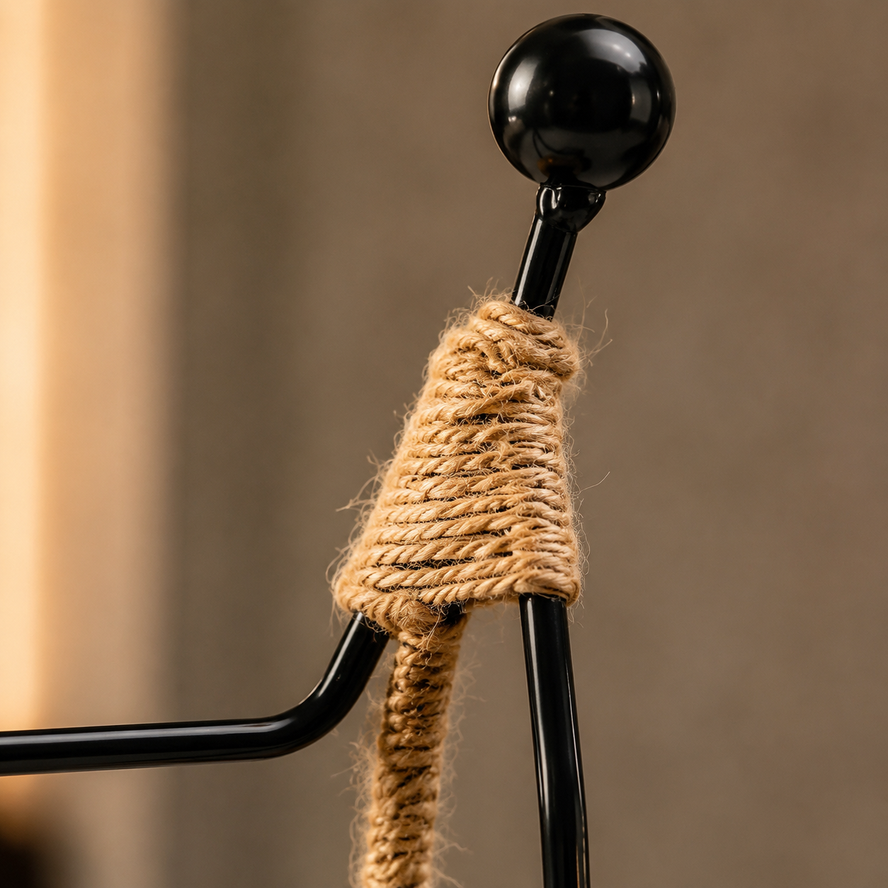 Close detail of Aura rope-wrapped body and glossy black metal frame