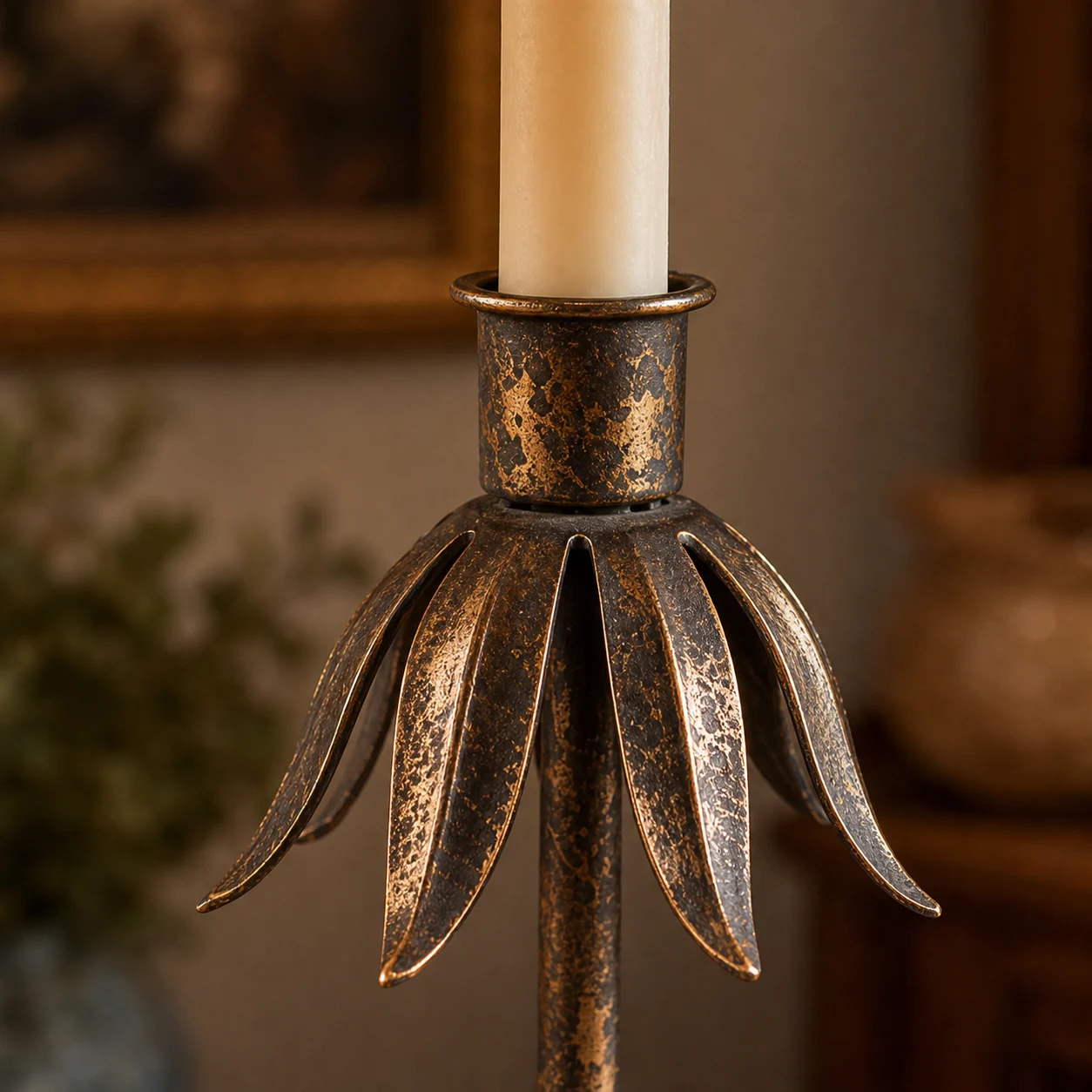 Close-up of candle cup and curved petal-like metal leaves