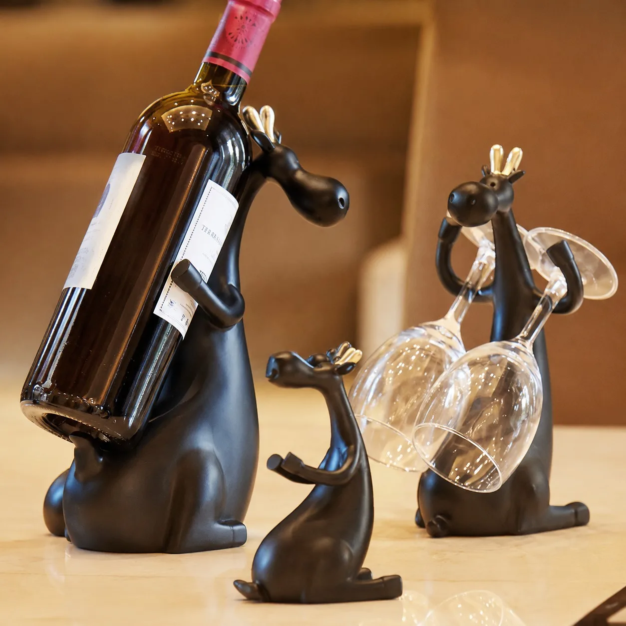 Forma black resin wine bottle holder figurine set displayed with bottle and stemware