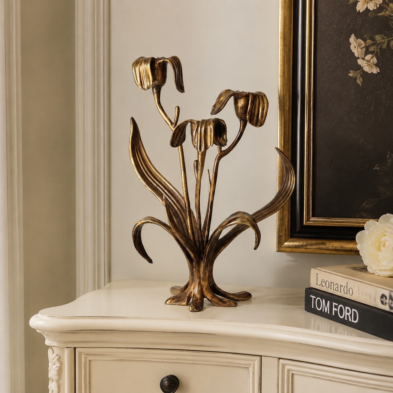 Aura Iris candle holder on a cabinet beside framed artwork and books