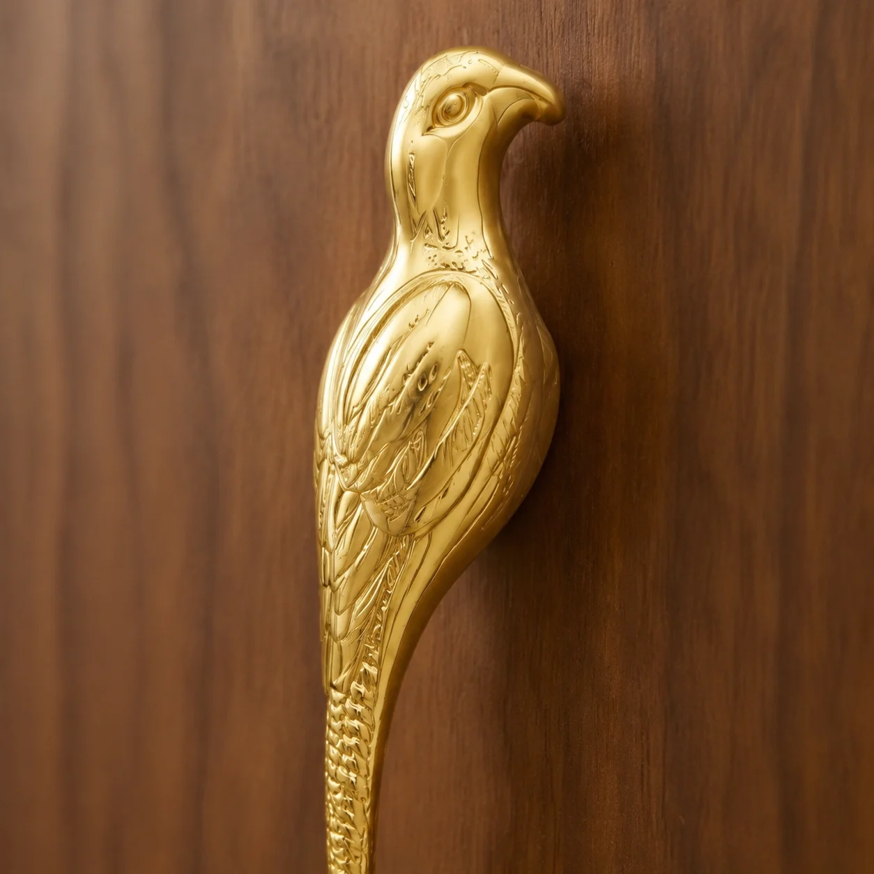 Close-up of the Totem brass bird-shaped cabinet handle