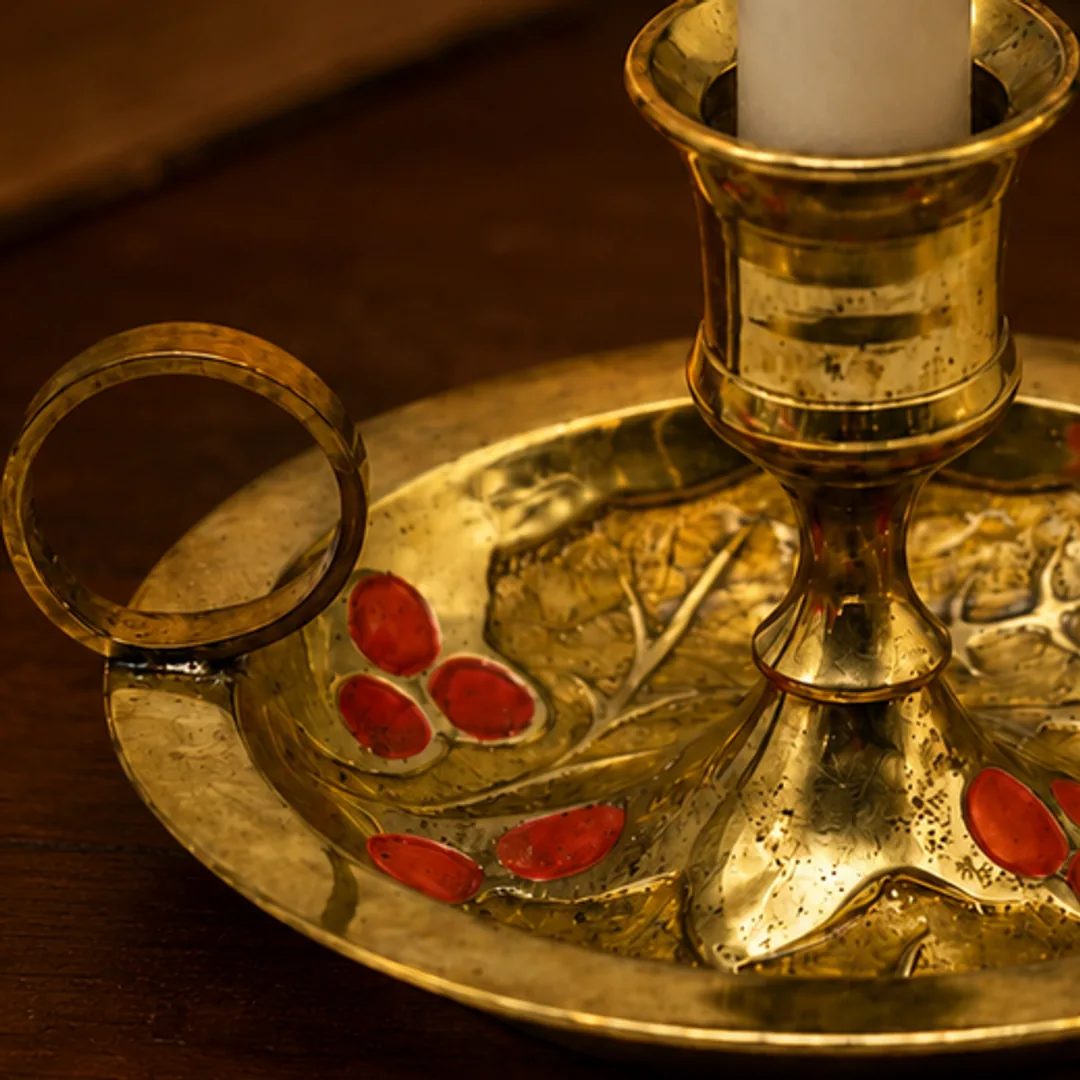 Close-up of the round side handle on the Aura candlestick