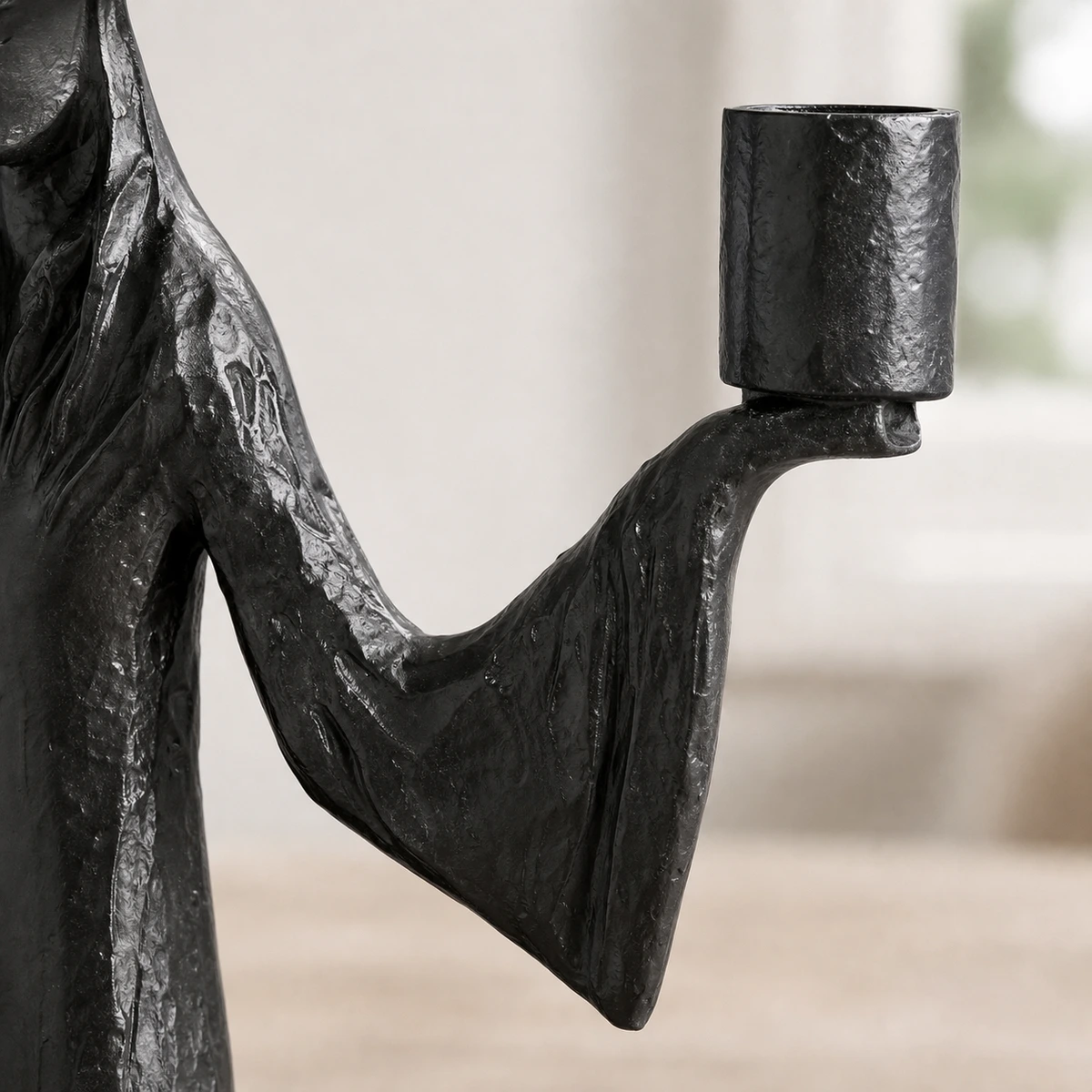 Close-up of the sleeve and arm support structure beneath the candle cup