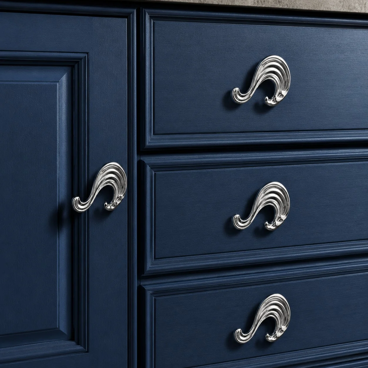 Chrome wave handles on blue drawers