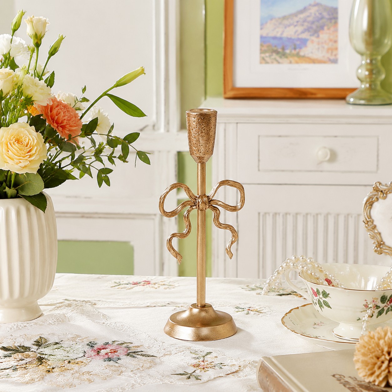 Aura gold candlestick holder on floral tabletop