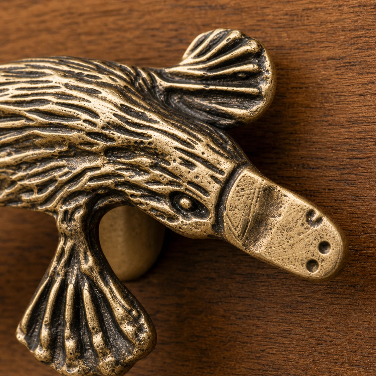 Close macro of Totem platypus handle head, bill and carved copper texture