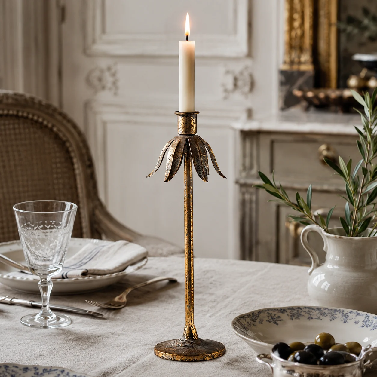 Tall Aura candlestick on a dining table with antique decor