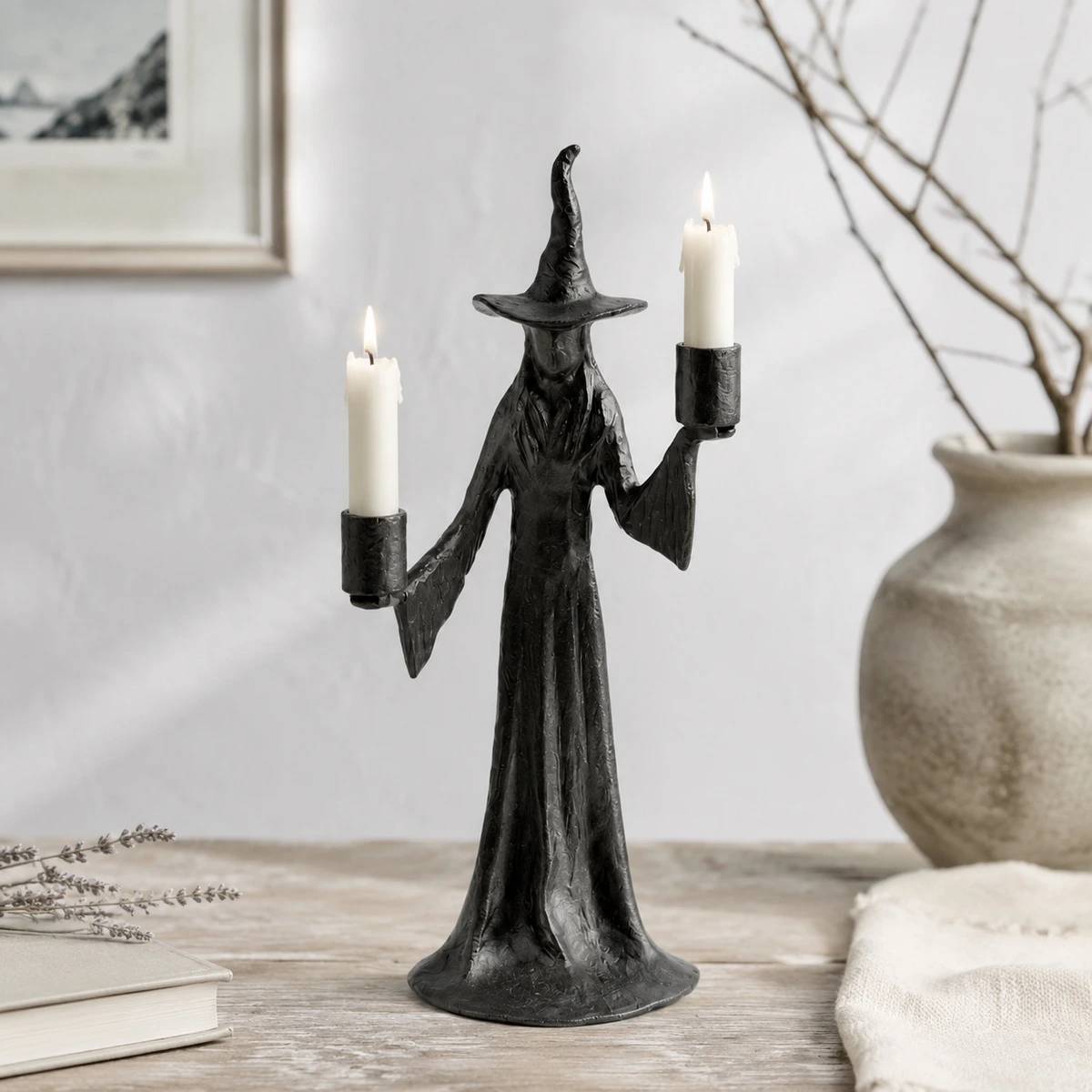 Double Candle Aura candlestick with two lit candles beside neutral vase and decor